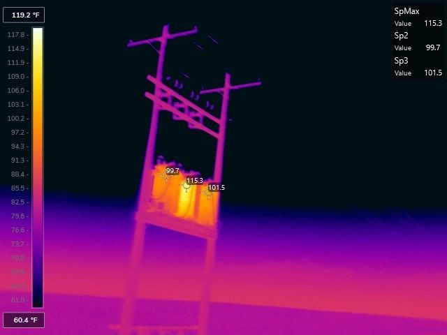 This thermal image shows a powerline utility pole with electrical transformers with temperature differences for preventative maintenance